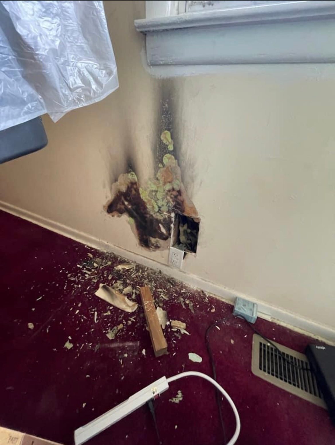 A wall with water damage and a hole before RFCP repaired it